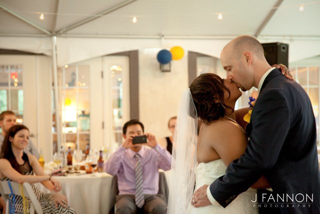 man taking pictures of newly wed couple
